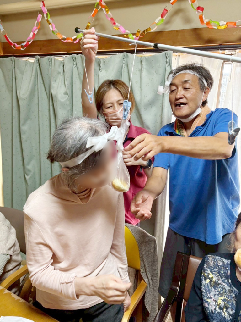 パン食い競争でパンにかみつく利用者さま